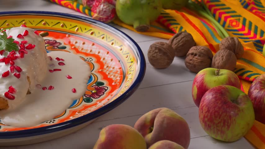 Chile en Nogada. Traditional Mexican cuisine on rustic wooden table