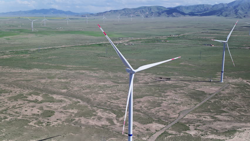 Qieji, Qinghai, China - 18th July 2026 - Panoramic Aerial View of Wind Turbines in Qieji Township Wind Farm, Gonghe, Qinghai: Wind Turbine Array, Vast Prairie and Clean Energy Base