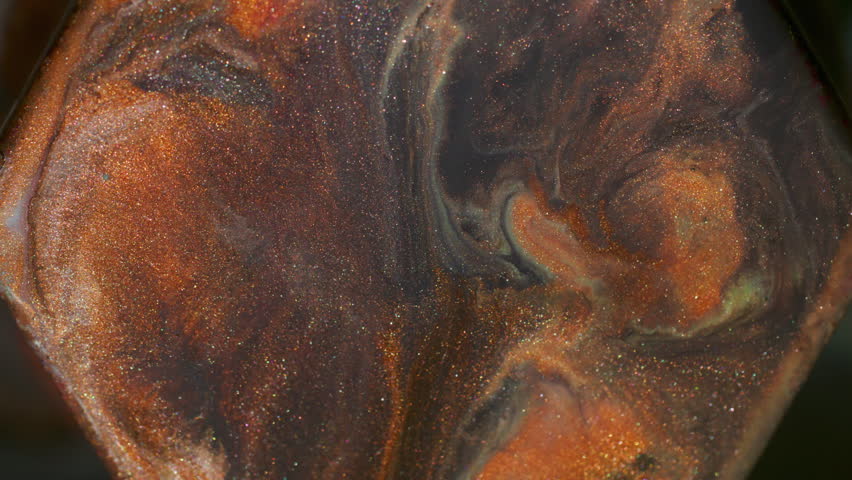 Paint splash. Pigment spill. Defocused orange purple yellow color glitter stone ink geometric particles rhombus floating on abstract art background.