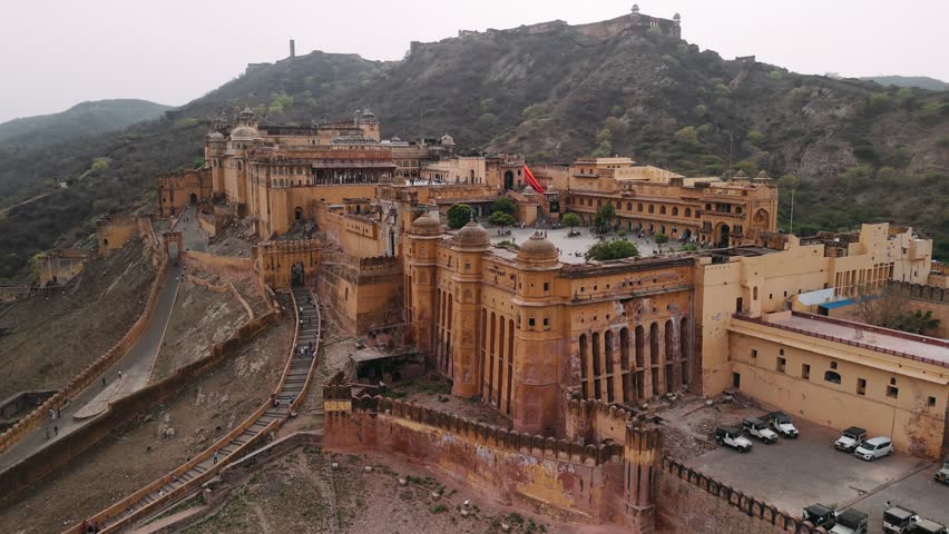 Aerial view of amber fort, a famous historic landmark with tourists walking in the main courtyard in jaipur, india.