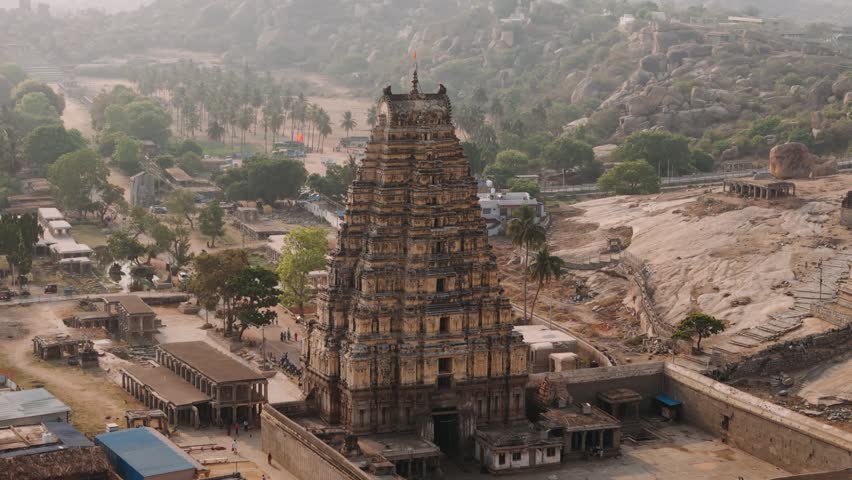 Aerial view of Virupaksha temple towering over the historic ruins of hampi, a unesco world heritage site in india.