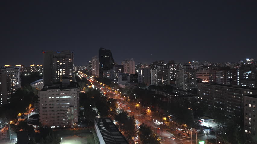 Aerial view of Beijing, China, at night, showing residential buildings and street lights.