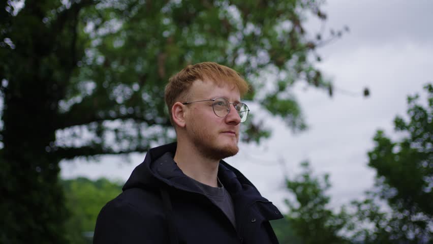 Creative person standing in nature with dramatic cloudy sky
