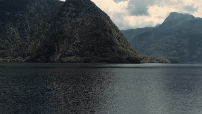 Calm Lake Water Surface with Mountain Landscape Background