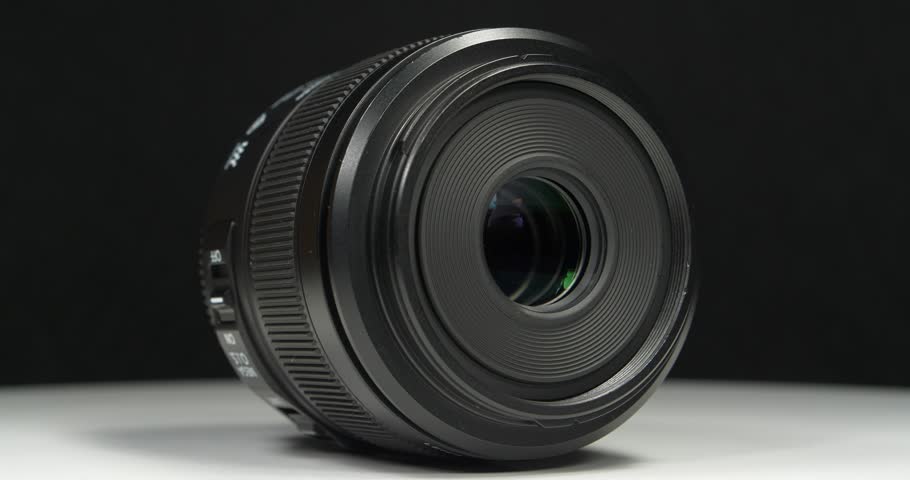 Black macro camera lens, video on black background