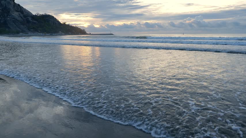 Dramatic Blue Sky with Clouds Over Wide Ocean Horizon and Beach	