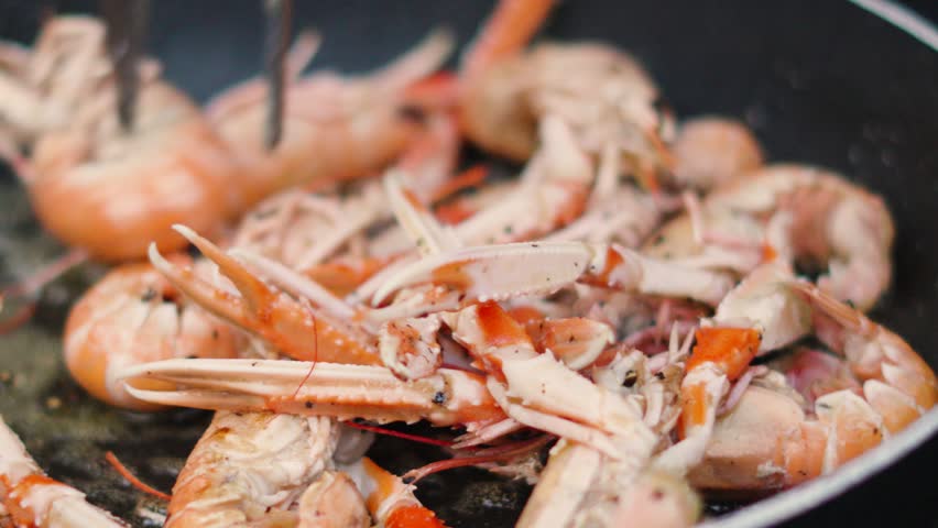 Fresh Langoustines Cooking in Hot Pan. Shellfish Seafood being Cooked Outdoors in Slow Motion. Norway Lobster.