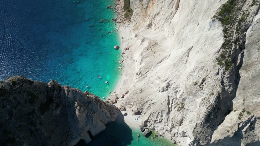 Aerial view of the turquoise waters and white limestone cliffs of Navagio Beach in Zakinthos, Greece.