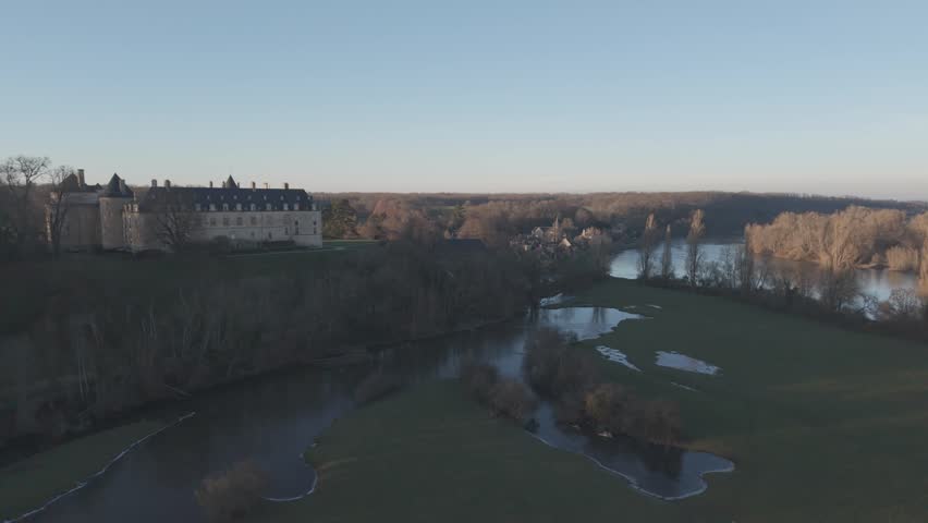 An aerial view shows a riverside building beside the braided sandbanks and channels of the Loire River.