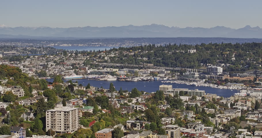 Seattle Washington Aerial v143 zoomed 3x flyover above Queen Anne, Eastlake, Westlake, South Lake Union and Capitol Hill toward the Cascade Mountains - Shot with Mavic 3 Pro Cine - Oct 6th 2023