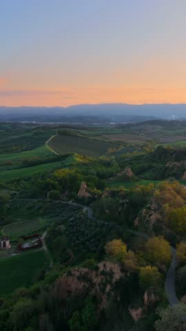 Aerial view of rolling hills and badlands of Le Balze at sunset in Piantravigne, Tuscany, Italy.