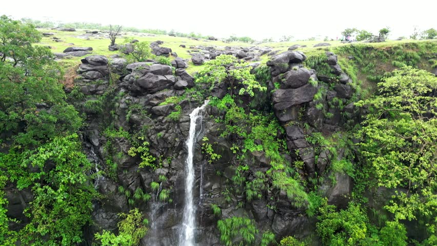 Aerial View of a Waterfall Cascading from a Rocky Plateau.