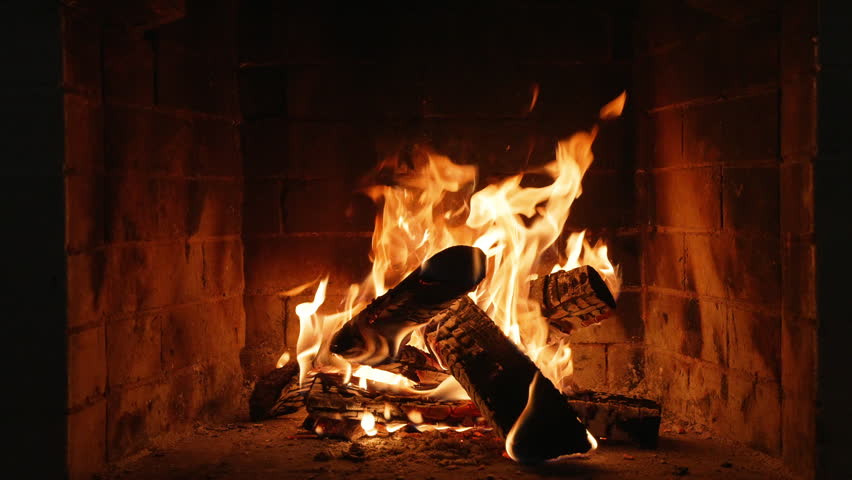 Burning Fireplace Providing Warmth and Comfort. Flames Dancing and Creating a Warm Glow in a Cozy Fireplace, Perfect for a Winter Evening, Christmas or New Year's Eve Celebration