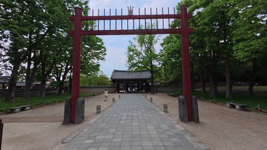Traditional stone wall and rooftop at Gyeonggijeon Shrine in Jeonju, South Korea.