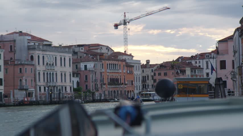 View from boat of canal buildings and construction crane