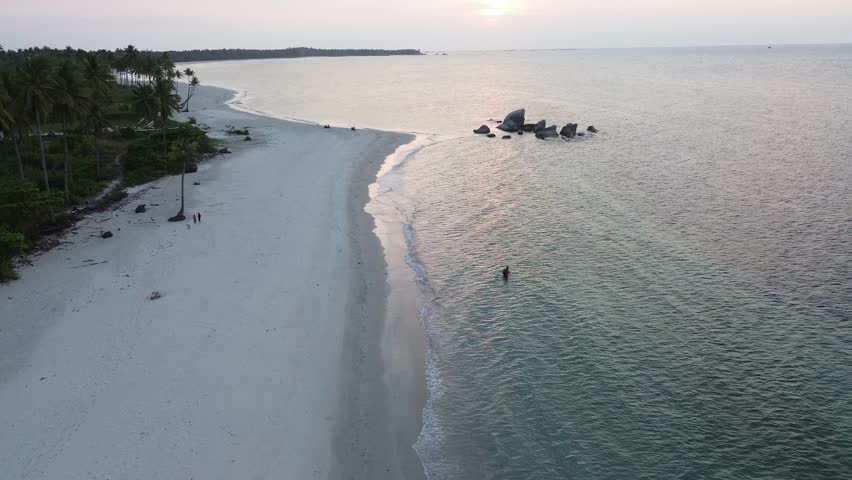 Traditional Fishing Activity on Coastal Waters at Sunset