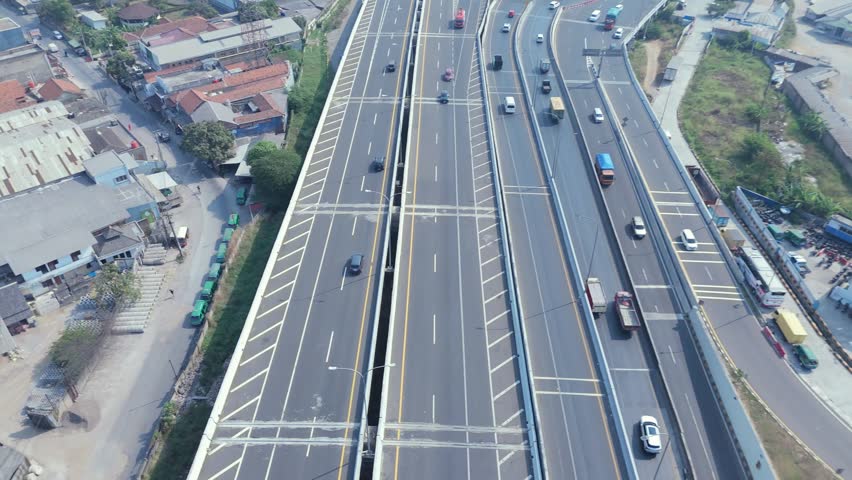 Top View Highway Lane Stretching Through Green Landscape Under Bright Daylight