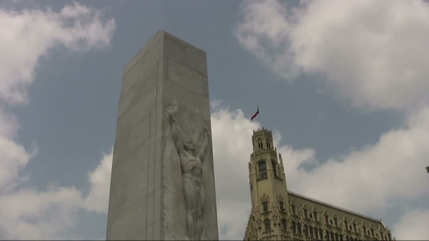 Video time lime lapse the Alamo Cenotaph monument in front of Alamo and Emily Morgan Hotel with Texas Flag. San Antonio, TX.Historic  famous. Don Despain of Rekindle Photo