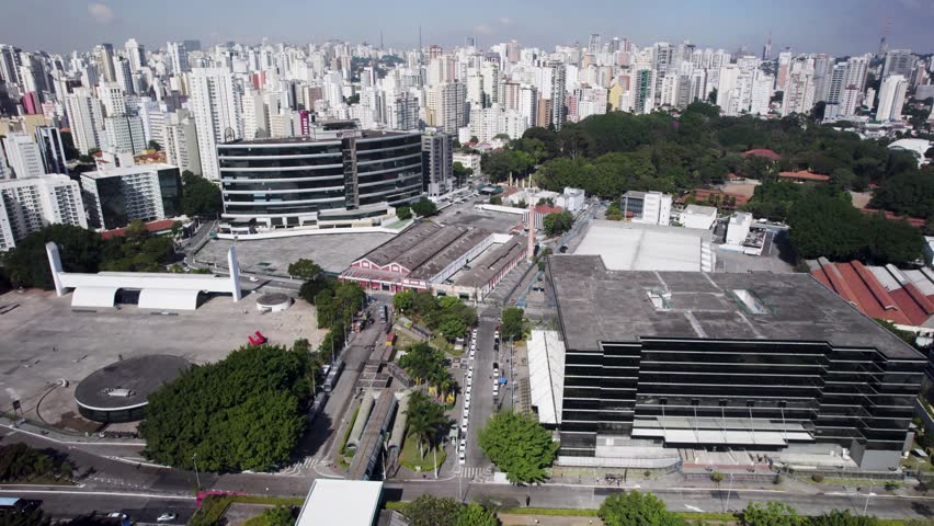 Travelling drone for the left showing te Memorial of America Latina infirst plan and São Paulo´s Skyline with a lot of buildings in the background