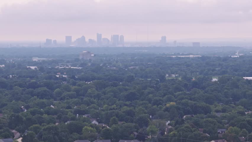 Drone aerial above city of Hilliard, Ohio suburban landscape as a suburb outside Columbus, OH with townhomes, residential units, duplex homes, houses, and rental buildings in middle class neighborhood