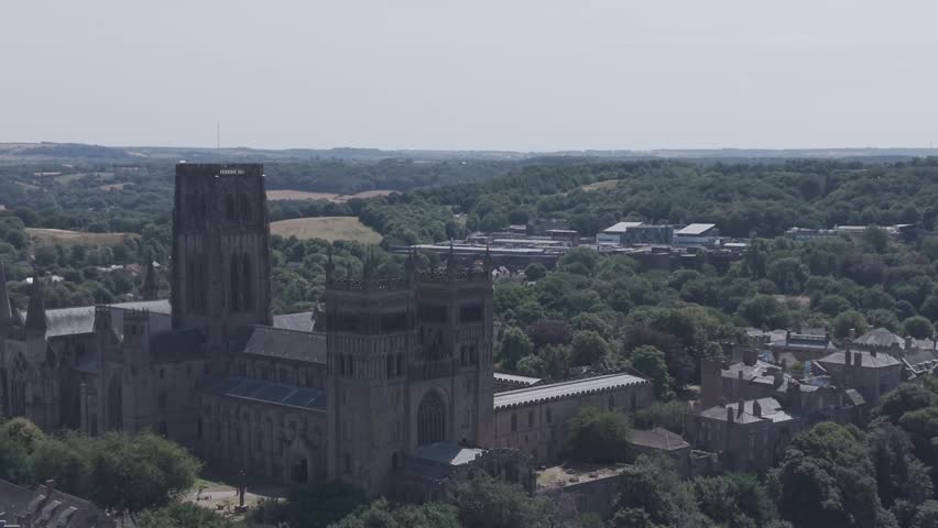 DURHAM, UK - AUGUST 2026: Scenic aerial shot of historic Durham Cathedral, River Wear and cityscape in County Durham (M-Log Flat Profile)