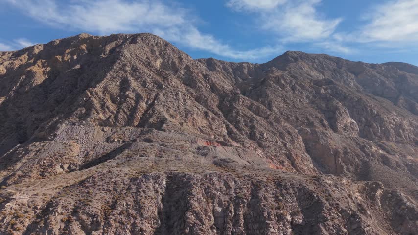 Rugged Andean mountain peak with rocky slopes in San Juan, aerial orbit