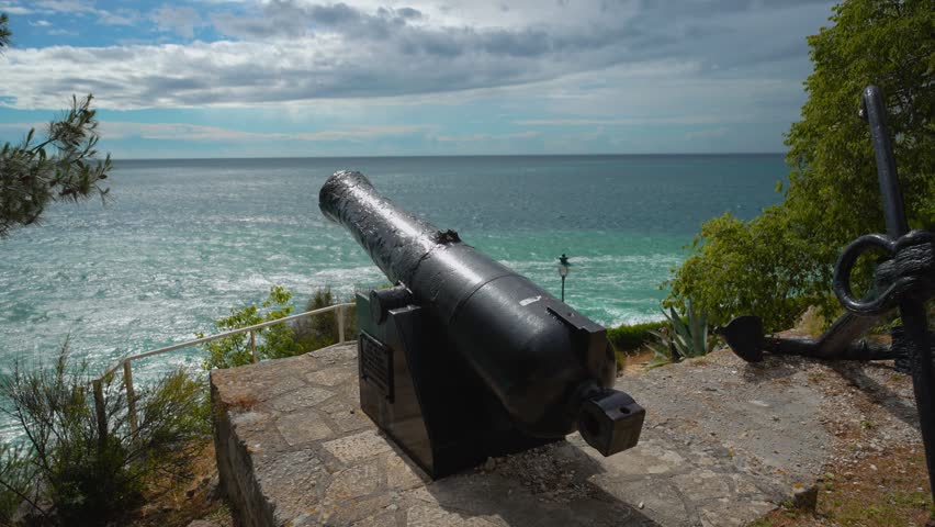 Historic old cannon t the coastal fortifications of Rovinj old town, Croatia, facing the blue sea.