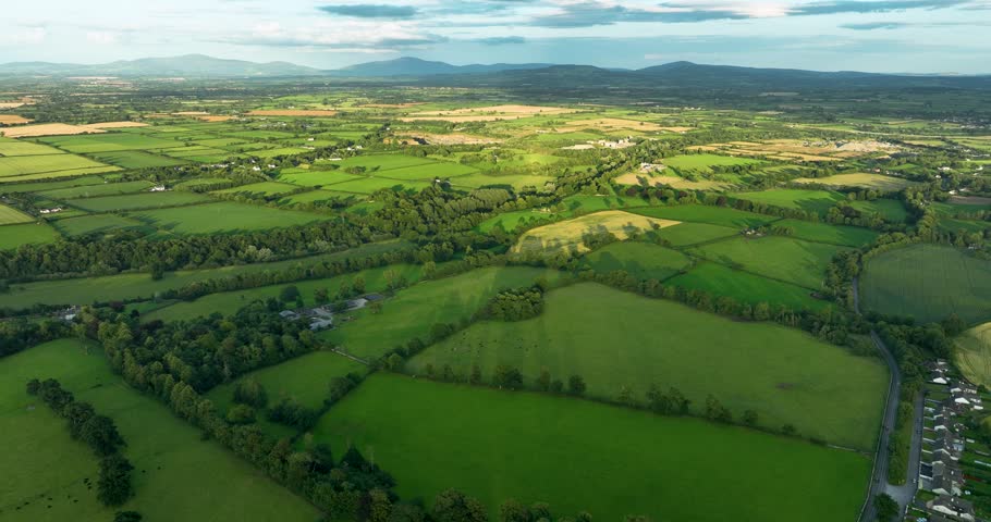 Aerial drone flying forward over green Irish countryside valley