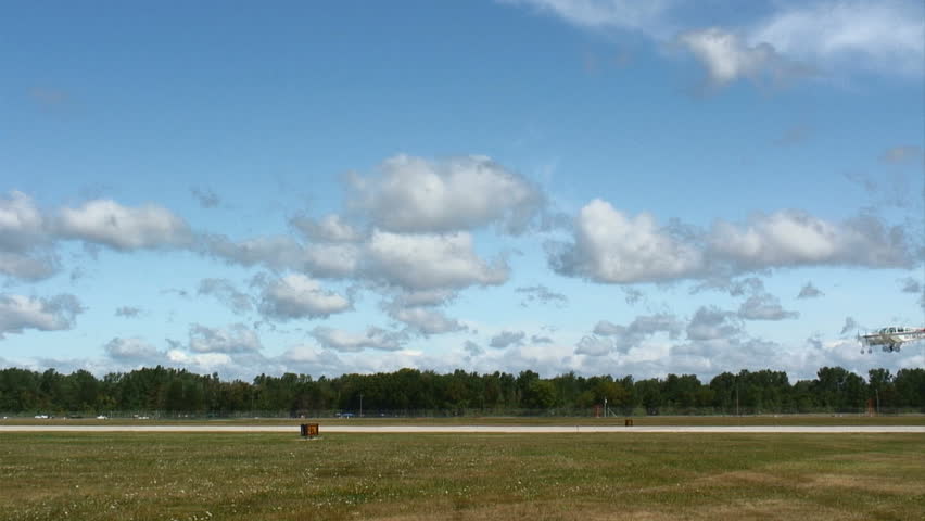 Beechcraft Bonanza, small plane landing at an airfield.