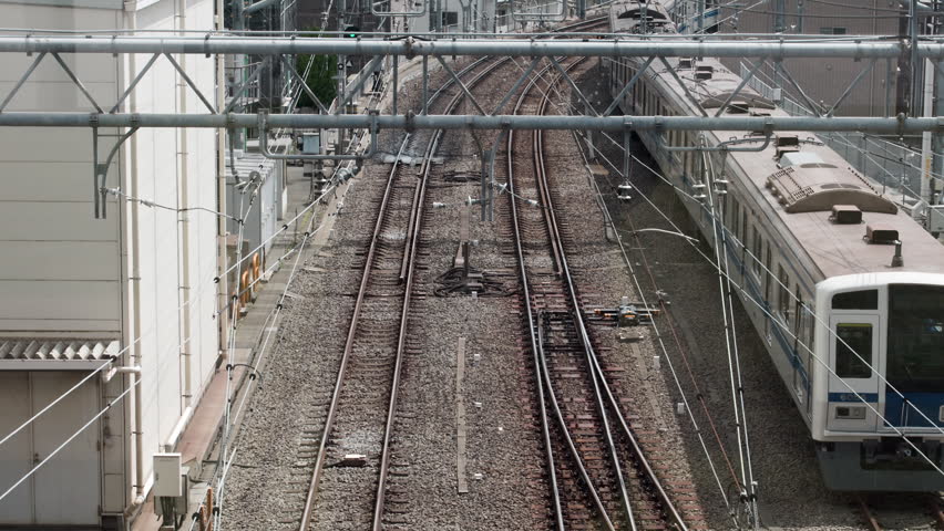 Tokyo Scene  :  Overhead View of a Commuter Train Leaving the Terminal, Clearly Showing the Pantograph and Rooftop Details  |  Ikebukuro, Tokyo, Japan