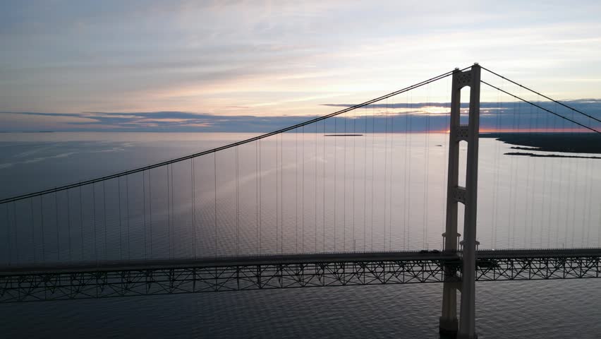 Slow steady shot of Mackinac Bridge at sunset.