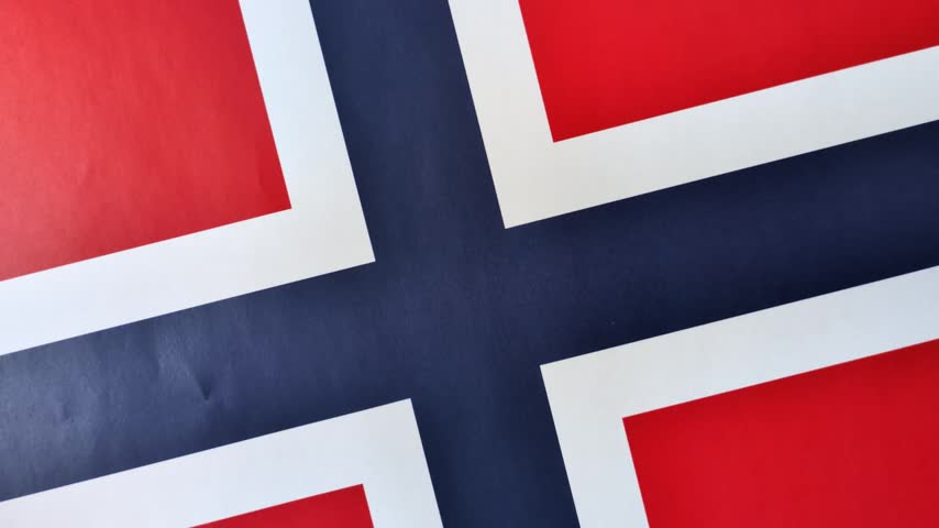 Norwegian national flag in red, blue and white color as a symbol of independence. Flag of Norway
