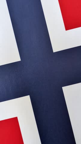 Norwegian national flag in red, blue and white color as a symbol of independence. Flag of Norway