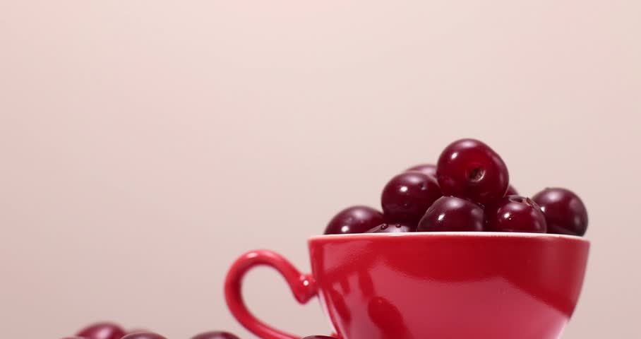Cherry in a red cup on a white background

