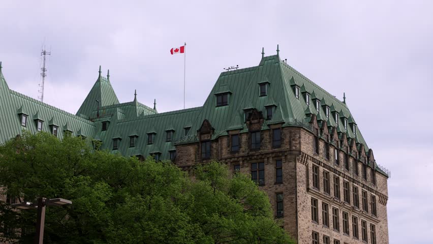 Confederation Building chateau style architecture and Canadian flag.