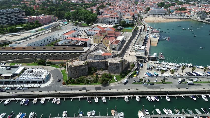 Aerial drone footage of Citadelle de Cascais Portugal 16th-century coastal fortress marina bay and Atlantic coastline panorama