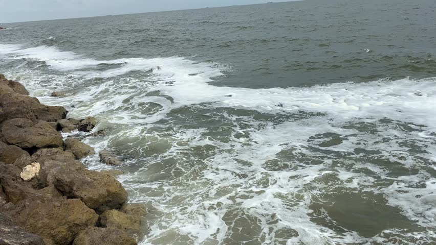 Powerful Ocean Waves Crashing Against Rocky Shoreline on Coast