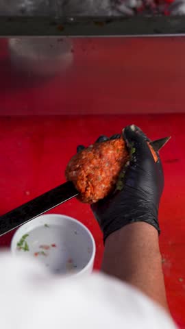 Chef Preparing Adana Kebab on Traditional Metal Skewer
