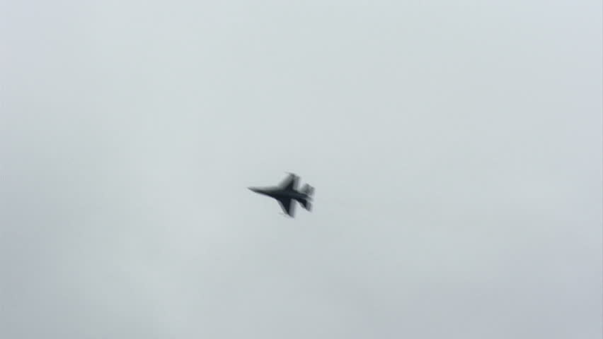 F-16 fighter plane performing aerobatics.