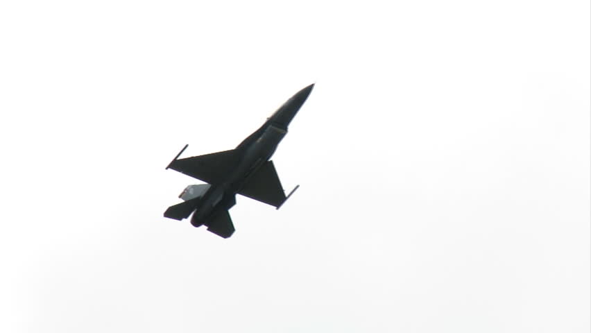F-16 fighter plane moving slow and close as it flies past the camera.