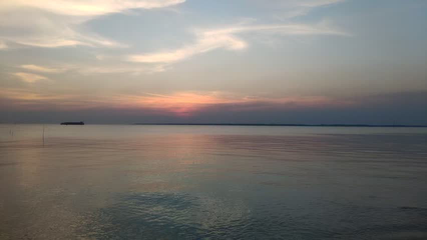 Peaceful seascape at dusk with orange and purple sky