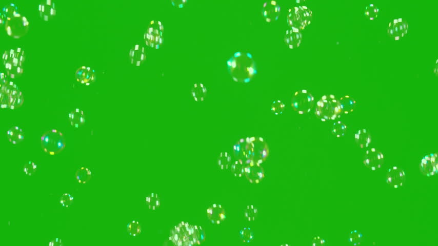 Transparent Bubbles Chroma. A large number of soap bubbles moving in one direction against a green background. Great for use in blending