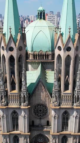 Panning wide of famous catholic church Metropolitan Cathedral of Sao Paulo at ground zero of downtown Sao Paulo Brazil located at Sé Square. Historic medieval building. Religion scenery.