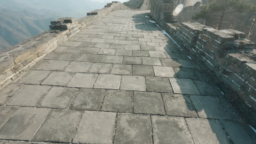 Stone-Paved Walkway and Weathered Ramparts Along a Mountain Ridge of the Great Wall of China