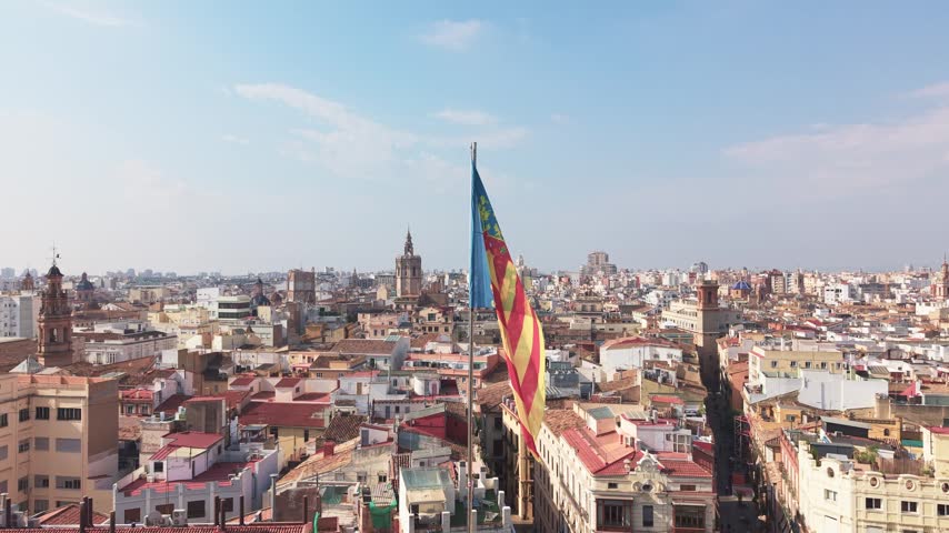 Flag of Valencian Community above historic skyline of Valencia Spain