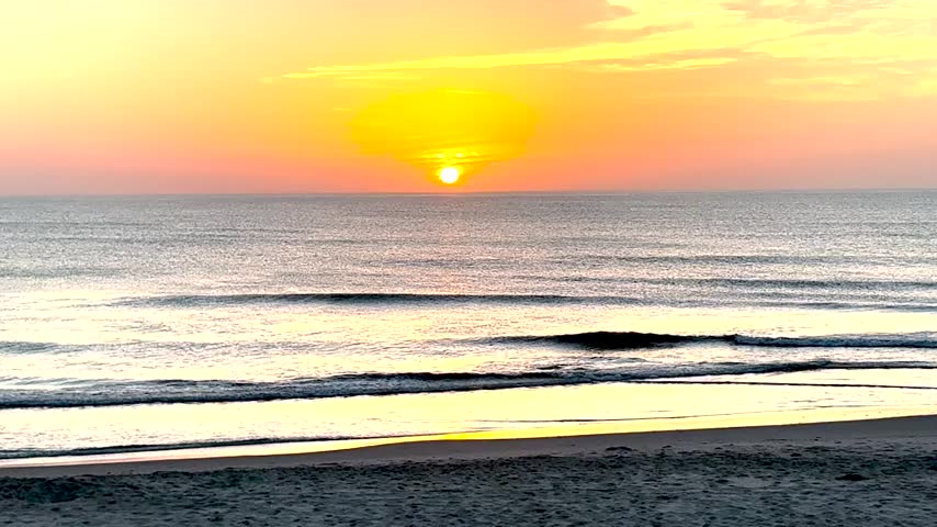 Orange and Red Glow of the Sunrise over the Atlantic Ocean in Corolla North Carolina on a mid August dawn.
