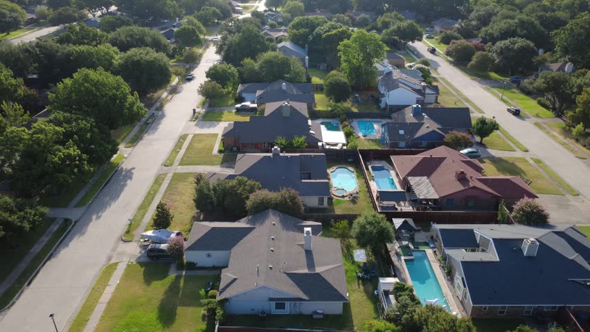 Private rectangular swimming pools grace fenced yards along Mobley Way across DFW area. Covered wooden pergolas, multi pitch rooflines highlight backyard comfort, Coppell, Texas. USA