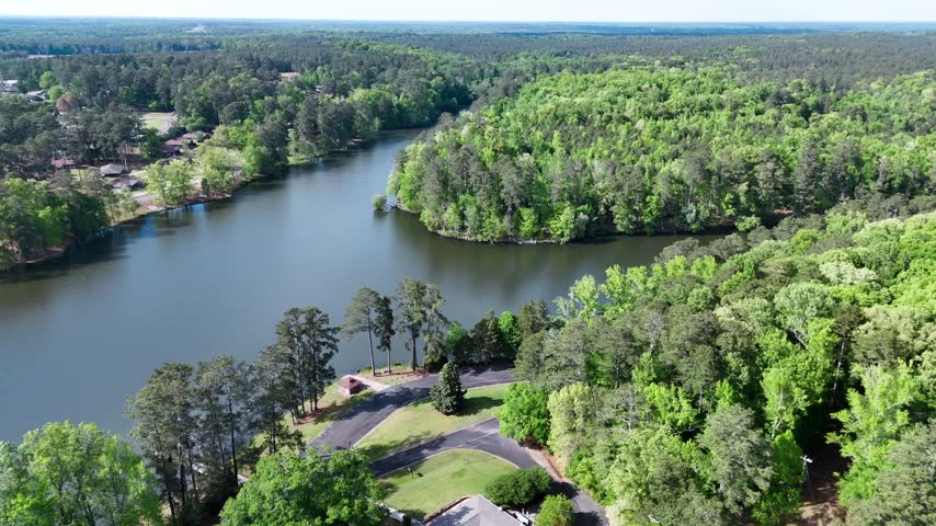 Aerial view across wooded peninsula and lake shoreline at Rock Eagle in Putnam County Georgia