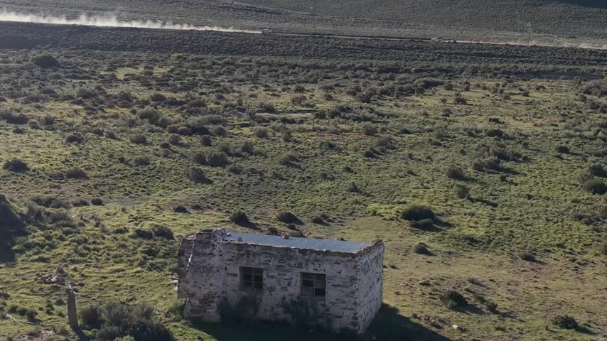 Atmospheric view of abandoned buildings with weathered walls and broken windows, symbolizing decay, forgotten history, and urban exploration themes in rural or industrial landscapes.
