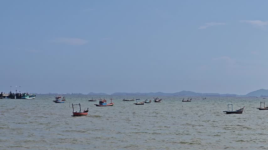 A small fishing boat is moored at the shore